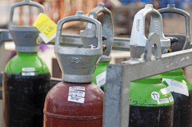 Umea, Norrland Sweden - April 8, 2020: different types of gas bottles for welding and construction clipart