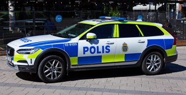 Umea, Norrland Sweden - June 20, 2020: Swedish police car has parked downtown on pedestrian street clipart