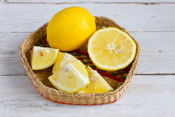 Lemon Wedges Wicker Bowl White Wooden Background — Stock Photo, Image
