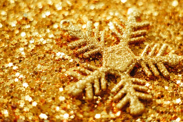 Golden Christmas background from sparkles of stars. blurred — Stock Photo, Image