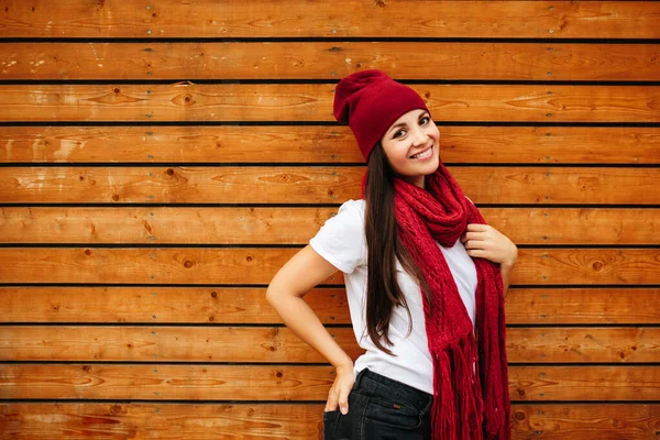 Attractive laughing female standing against wooden wall background with copy space area — Stock Photo, Image