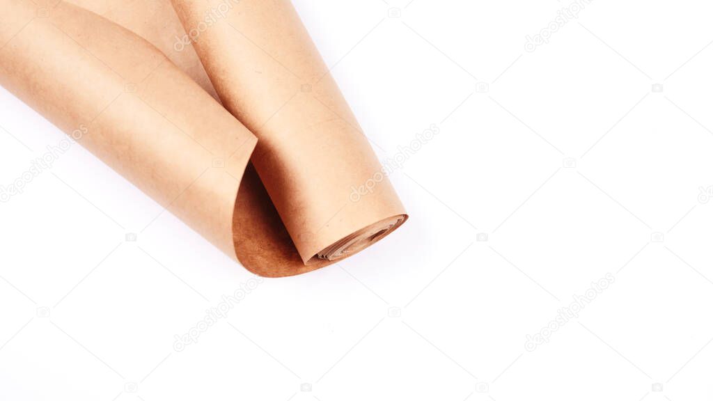Twisted into roll brown wrapping paper on white background.