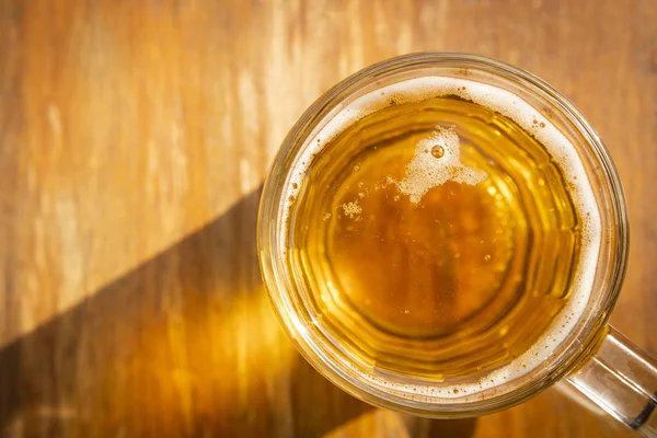 top view glass of beer on wooden table background