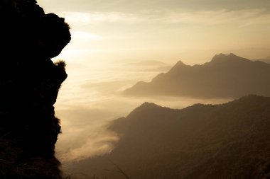sis ve dağlar cliff, Chiang rai, Tayland silueti ile altın güneş ışığı