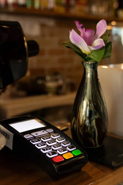 payment terminal or credit card machine on table at cafe