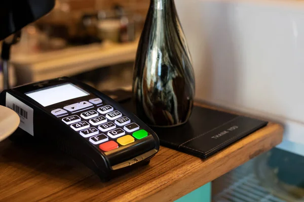 payment terminal or credit card machine on table at cafe