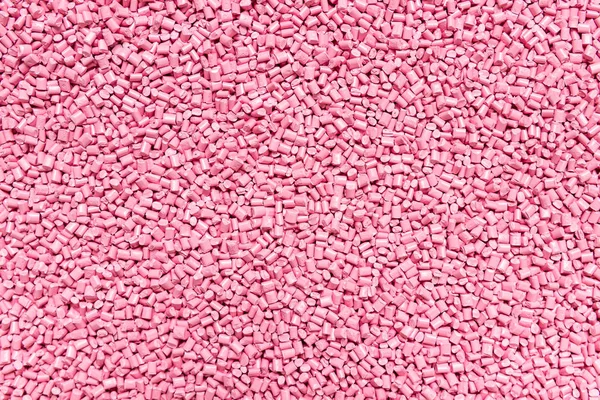 Гранулы из розовой пластиковой смолы (Masterbatch) для фона — стоковое фото