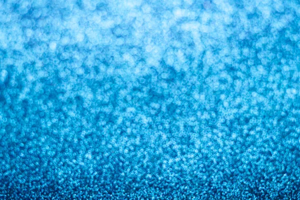 Abstract blue glitter background. Sparkle blue bokeh christmas background.