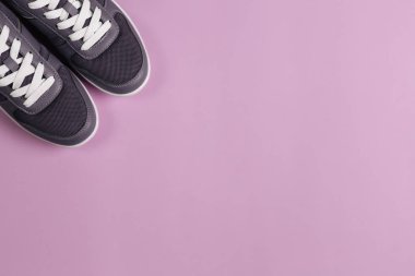 Mor arka planda gri spor ayakkabılar. Sağlıklı yaşam tarzı ve günlük eğitim kavramı.  