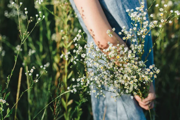 日光の下で牧草地に野の花の花束を持つ美しい女の子 夏の背景 — ストック写真