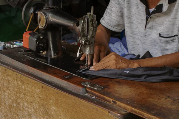 A traditional tailor in action at work