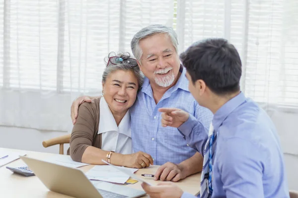 Happy retired Asian senior eldery couple consult with personal financial advisor or real estate agent. Retirement investment planning with professional counseling. Home loan and mortgage concept
