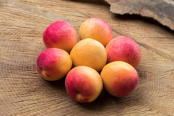 Ripe apricots on stump composed in the form of flower, vega food