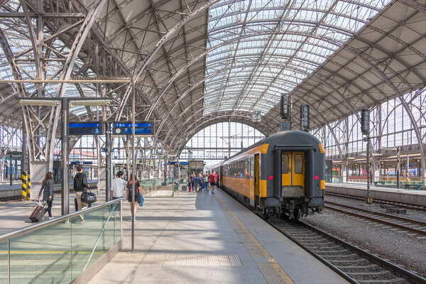 Passengers board a train on the Prague main railway station