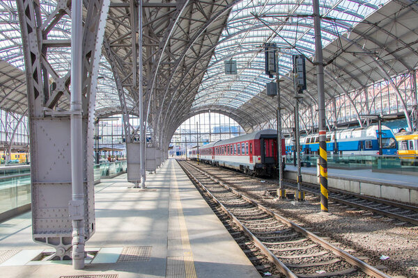 Prague main railway station with red, blue and yellow train, Czech Republic