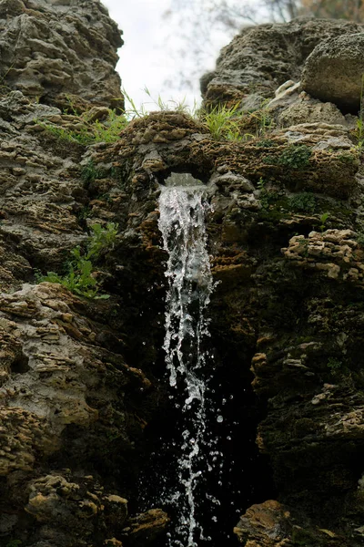 A waterfall, a drop of water that originates from rock
