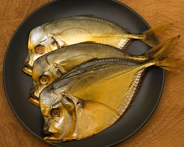 Three Smoked Vomer Fish Lie Black Plate Wooden Board — Stock Photo, Image