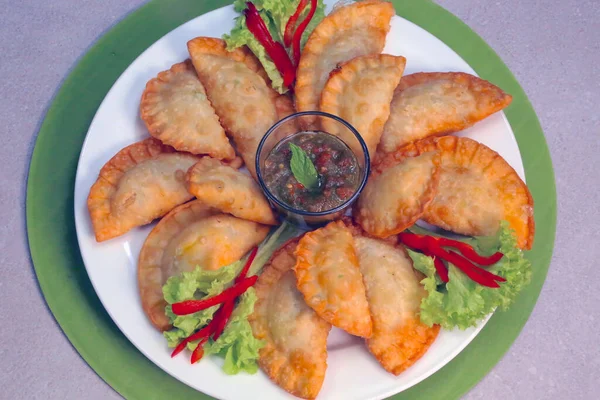 Deep-fried pastry stuffed with a mix of meat, onion & spices. Arabic Dish