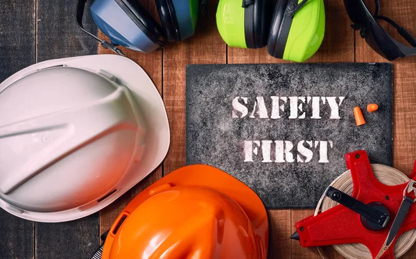 Safety first sign with personal protective equipment