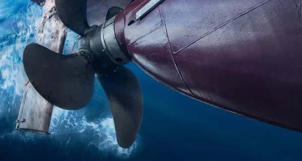 Propeller and rudder of big ship underway view from underwater. Close up image detail of ship.