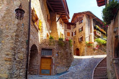 Canale di Tenno - İtalya'da güzel ortaçağ köyü, Göl Lago di Garda, pencerelerde taş duvarlar ve çiçekler ile dağlarda hisoric köy, dar arnavut kaldırımlı sokaklar