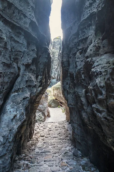 Narrow stone path between rocks in sandstone mountains