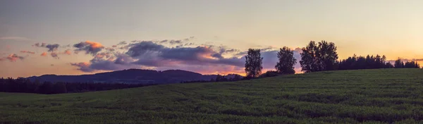 Panorama landscape at sunset - clouds illuminated by the setting sun — Stock Photo, Image