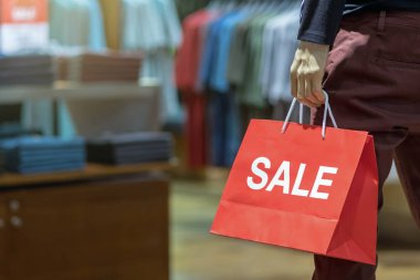 Erkek manken alışveriş, iş moda ve reklam kavramı için alışveriş mağazası satış kağıt alışveriş çantası holding rahat kıyafetler giymiş bir parçası