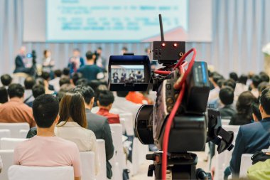 Closeup Video konferans salonu veya seminer toplantı, olay ve seminer kavramı seyirci arkadan görünüm üzerinden Sahne Alanı'nda hoparlör resmi takım elbise ile kayıt