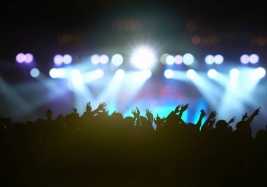Concert crowd in silhouettes of Music fanclub with show hand action which follow up the songer at the front of stage with follow light, musical and concert concept clipart