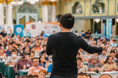 İzleyici konferans salonu veya Seminer Toplantı, iş ve eğitim kavramı Asya hoparlörün arka görünümüyle ayakta ve fotoğrafın üzerine bilgi veren geçici takım bulanık