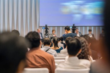 Sahnede, iş ve eğitim yatırım kavramı hakkında hoparlörlere sahip konferans salonu veya seminer toplantı seyirci görünümünde arka