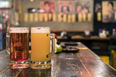 İki bardak bira ahşap tablo içinde bar ve restoran. Sakin ol ve konsept iç
