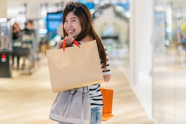 Glad Asiatisk Kvinna Hålla Shoppingväskan Och Letar Nya Modekläder Genom — Stockfoto
