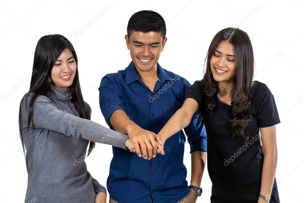 Portrait of three asian model with casual suit with Hand coordination action on white background, friendship and teamwork concept, include cliping path