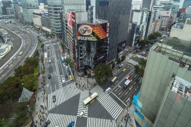 TOKYO, JAPAN - OCTOBER 2017 : Top view of Undefined Japanese people crowd are walking to crosses the street between the buildings of Ginza JR station which is district on October 28, 2017 in Tokyo, Japan. clipart