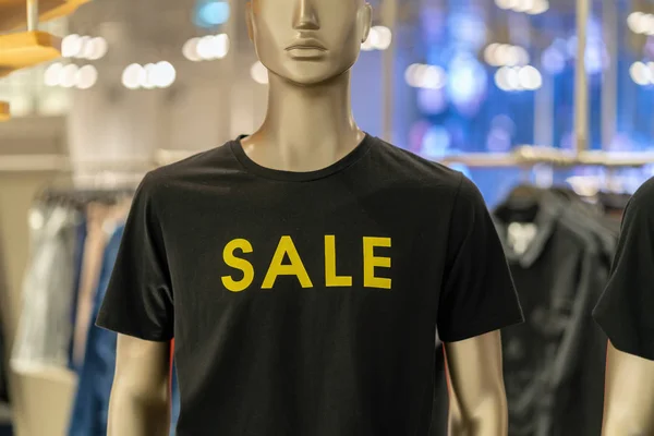 Part of female mannequin dressed in casual clothes with SALE text in the shopping department store for shopping, business fashion and advertisement concept