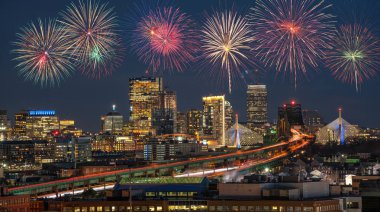 Multicolor Firework Celebration over Scene of Boston skyline which can see Zakim Bridge and Tobin Bridge with express way over the Boston Cityscape, 4th of July and Independence day concept clipart