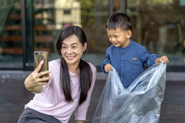 Asian single mom with son are selfie together when living in loft house for Self learning or home school, Family and single mom concept, selective focus