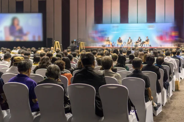 Konferans salonu veya Seminer Toplantı, iş ve eğitim yatırım kavramı hakkında sahnede hoparlörler dinleme seyirci arkadan görünüş