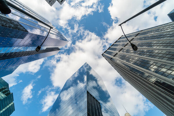 Uprisen angle scene of Downtown Chicago skyscraper with reflection of clouds among high buildings, Illinois, United States, Business and Perspective concept