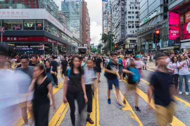 HONG KONG, HONG KONG - JULY 2019 : Crowd Unrecognizable Protester walking around Tsim Sha Tsui street area on July 7, 2019, Hong Kong, The fugitive law amendment sparks more thatn 1 million people clipart