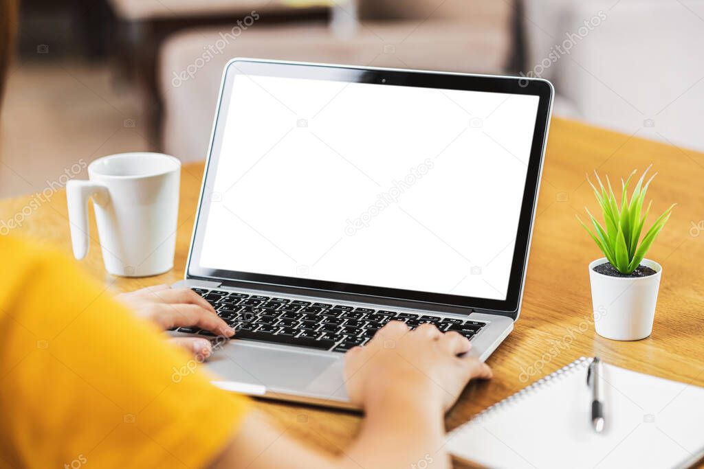 Back side of Asian business woman using laptop with white screen for creative and design in modern of house, working from home and stay at home when covid-19 outbreak,blank screen mockup copy space