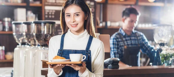 Banner of Asian Coffee shop owner serving bakery cake and coffee cup to customer in coffee shop, Small business owner and startup in coffee shop and restauran, waitress and barista concept