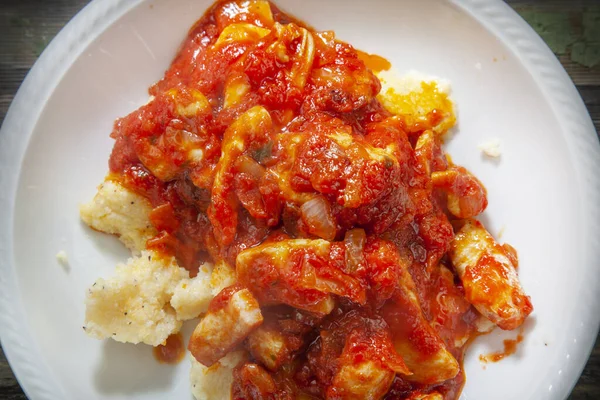 Closup Photo of Cooked Chicken With Mixed Tomato Spicy Sauce on Polenta