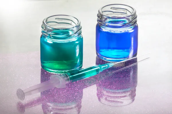 Closeup Photo Blue Green Liquid Glass Containers Syringe Infront Them — 스톡 사진