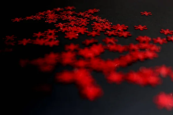 Red snowflake glitter sparkle isolated on black background — Stock Photo, Image