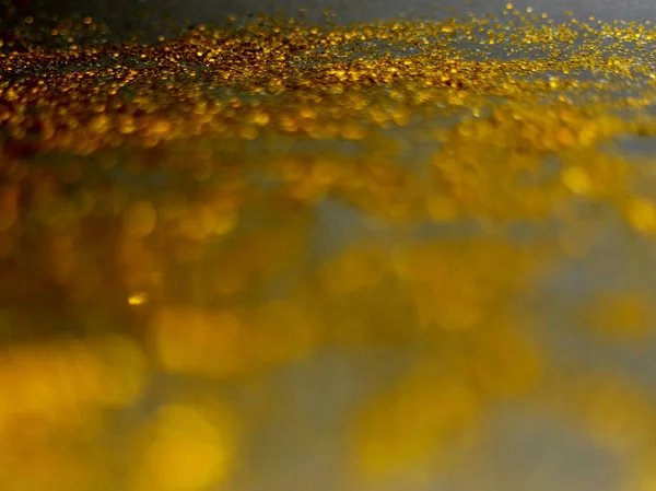 Golden glitter sparkle isolated on black background — Stock Photo, Image