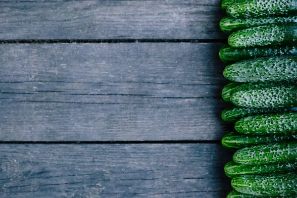 Cucumbers on wooden surface. Seasonal vegetables. Fresh vegetables. Healthy diet. Copy space