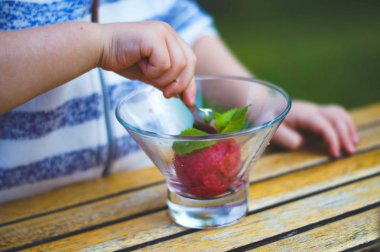 Cropped image of a child eating sorbet.
